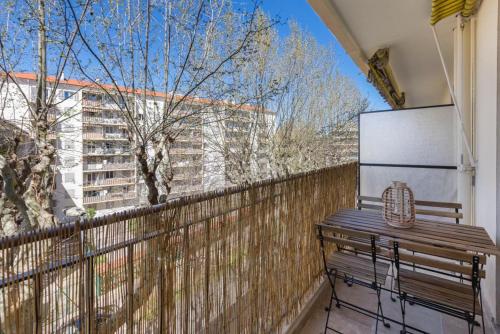 a balcony with a wooden fence and a bench at Antibes Calm: Your Coastal Haven in Antibes