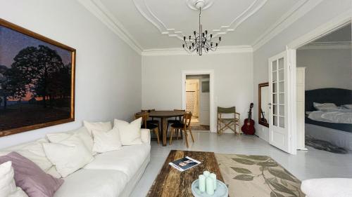 a living room with a white couch and a table at ApartmentInCopenhagen Apartment 1599 in Hellerup