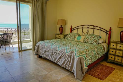 a bedroom with a bed with a view of the ocean at Paraiso del Mar Condominiums in Misiones de La Paz