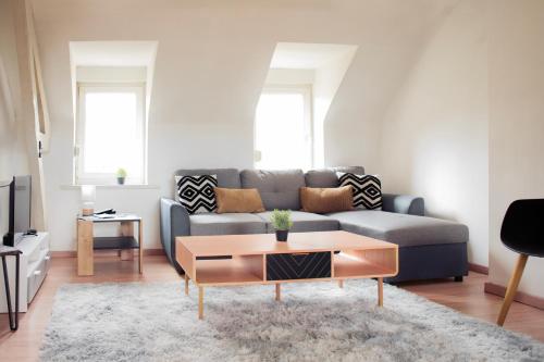 a living room with a couch and a coffee table at ++++ CENTRAL COSY DUPLEX ++++ A 5 MIN DES REMPARTS ET 12 MIN DE PLACE DALTON A PIEDS in Boulogne-sur-Mer