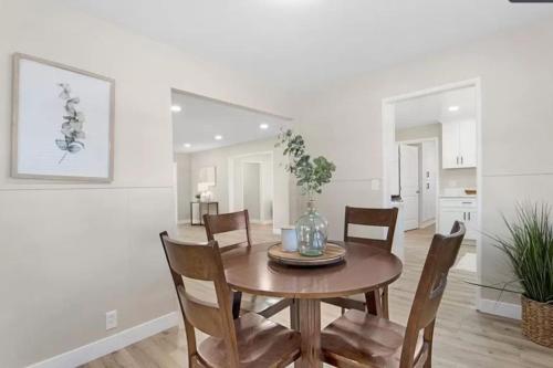 a dining room with a wooden table and chairs at Modern Home Near Ontario Airport in Ontario