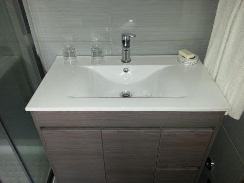 a white sink in a bathroom with a shower at Quinta da Cardal in Vila Verde
