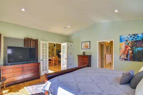 a bedroom with a large bed and a flat screen tv at Close to Hot Springs Chalk Creek Meadows Home! in Nathrop