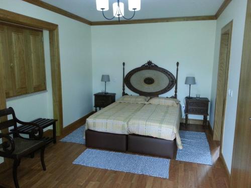 a bedroom with a large bed and two night stands at Quinta da Cardal in Vila Verde