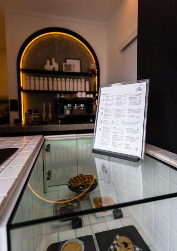 a display case with cookies and a sign on it at Praia Comprida Hotel in São José