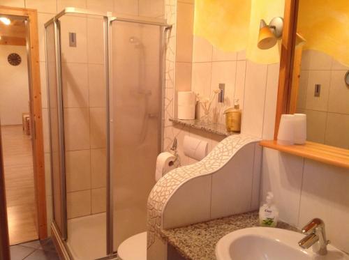 a bathroom with a shower and a sink at Holzbildhauerei Kammerer in Triberg