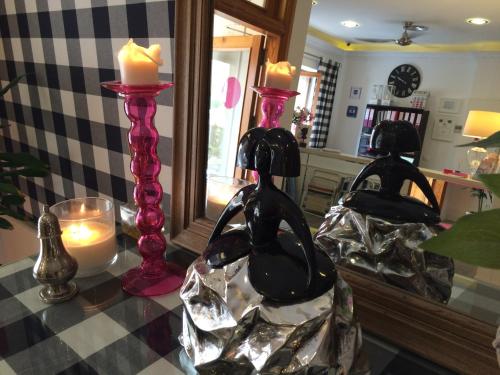 a table topped with two candles and a mirror at Hotel Jávea in Jávea