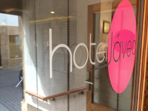 a pink surfboard on the window of a store at Hotel Jávea in Jávea