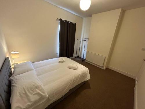 a white bed in a room with a window at 3 Bedroom Home From Home, Crewe in Crewe