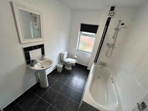a bathroom with a sink and a shower and a toilet at 3 Bedroom Home From Home, Crewe in Crewe