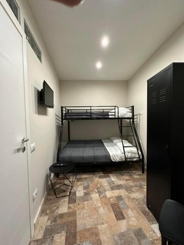 a bedroom with a bunk bed and a tiled floor at La dimora di Pino in Ripa