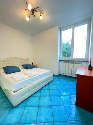 a bedroom with a bed and blue tiled floors at Putechella's Apartments in Maiori
