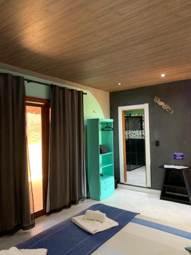 Ένα ή περισσότερα κρεβάτια σε δωμάτιο στο Pousada Villa Flamboyant