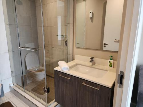 a bathroom with a shower and a sink and a toilet at The Trilogy Penthouse 1603 in Pretoria