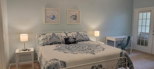a bedroom with a bed with two lamps and a table at Legacy Villa 805 in Gulfport