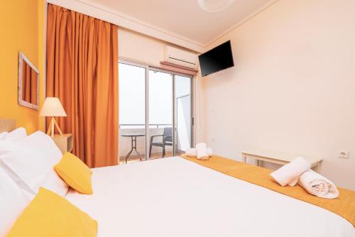 a hotel room with a large bed and a large window at City Life Marina apartment No. 2 in Ampavris