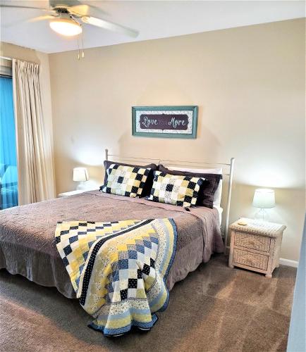 a bedroom with a bed with a checkered blanket at Legacy Tower II 602 in Gulfport