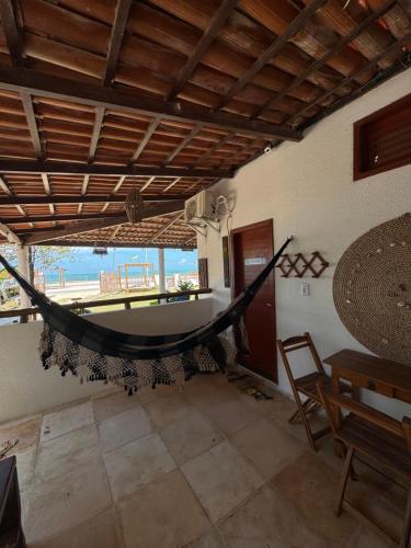 a hammock hanging from a wall in a room at Pousada das Canoas in Acaraú