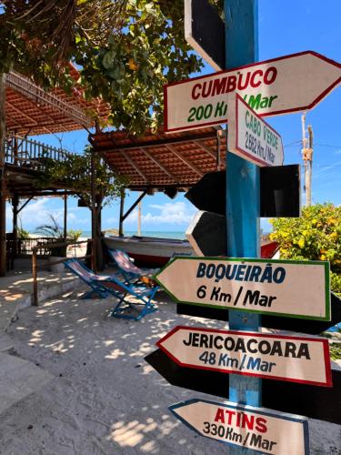 a bunch of street signs on a pole at Pousada das Canoas in Acaraú