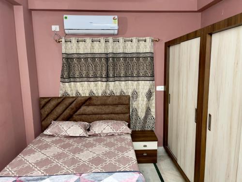 a small bedroom with a bed and a window at Prince Castle-2BHk Luxurious Apartment/Guesthouse in Hyderabad