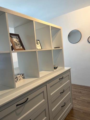 a dresser with a large glass display cabinet at Bellissima Apartment in Belgrade