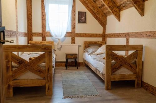 a bedroom with two bunk beds and a window at Zielony Domek/Green House in Załakowo