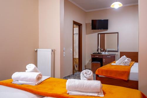 a hotel room with two beds with towels at Faros I in Piraeus