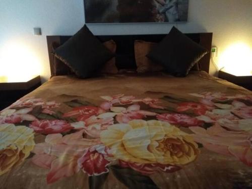 a bed with flowers on it in a bedroom at Anchors Aweigh-Sea View Apart. in Nea Skioni