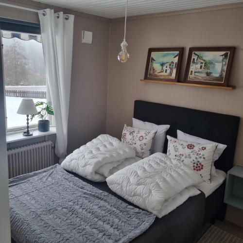 a bed with two pillows on it in a bedroom at Boende i Kristdala in Kristdala