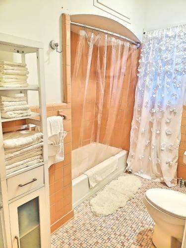 a bathroom with a shower and a toilet and a sink at Porter Avenue House in Biloxi