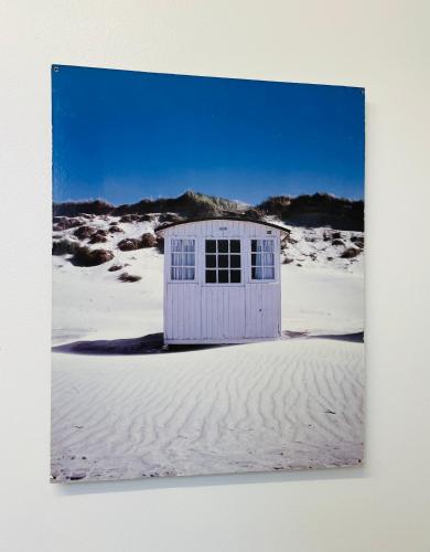 a small white building in the sand in the desert at The Crows Nest in Eyemouth