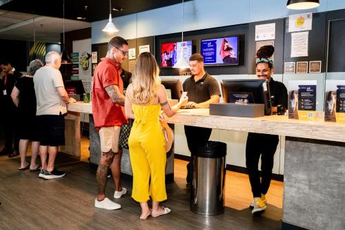 a group of people standing at a counter in a store at ibis Copacabana Posto 5 in Rio de Janeiro