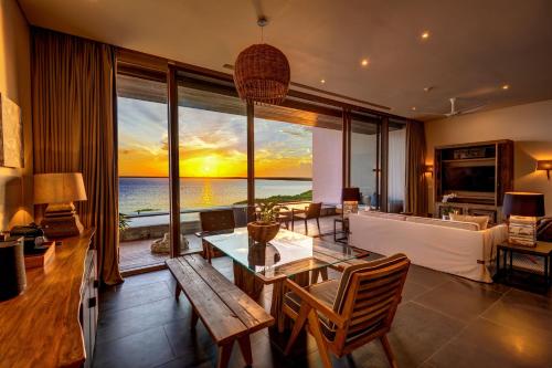 a living room with a table and a view of the ocean at NIZUC Resort & Spa in Cancún