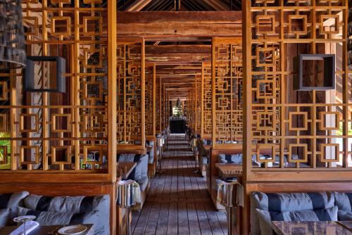a dining room with wooden tables and chairs at NIZUC Resort & Spa in Cancún