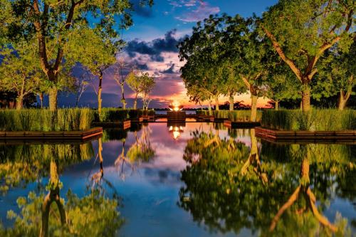 a reflection of the sunset in a pond at NIZUC Resort & Spa in Cancún