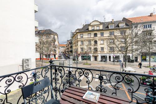 a bench on a balcony in a city with buildings at Appartement 2 chambres avec garage à strasbourg in Strasbourg