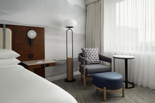 a hotel room with a bed and a chair at Marriott Long Beach Downtown in Long Beach