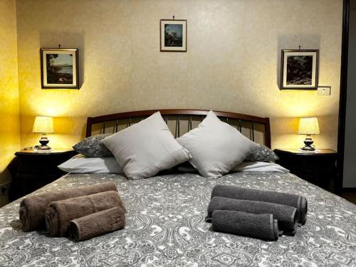 a bedroom with a large bed with two pillows on it at 3RDomus - Luxury suite con vista Duomo in Turin