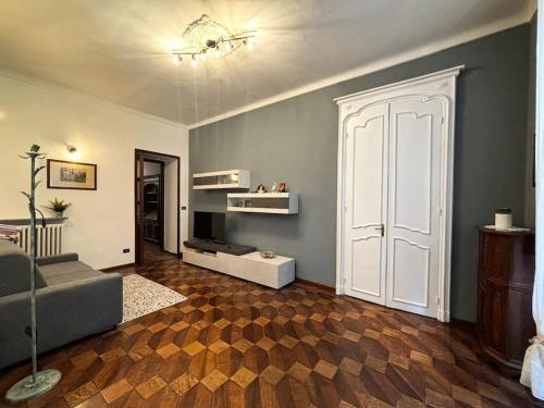 a living room with a couch and a white door at 3RDomus - Luxury suite con vista Duomo in Turin