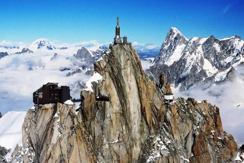 a mountain with a monastery on top of it at Casa Peghera, Chamonix (hypercentre) in Chamonix-Mont-Blanc