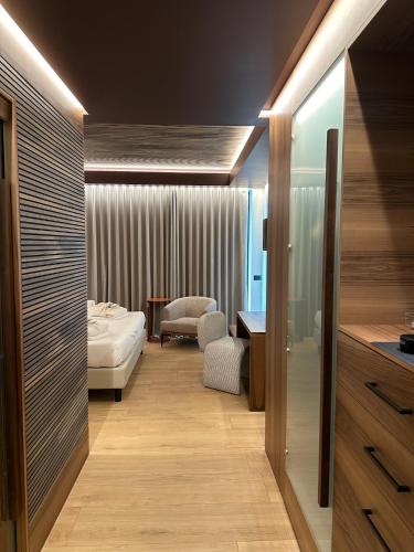a hotel room with a bed and a desk at Alevic Hotel Sirmione in Sirmione