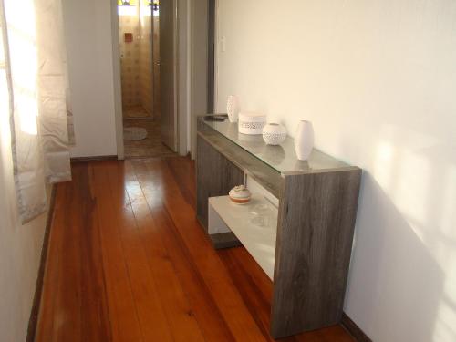 a room with a counter with vases on it at Oberherr in Gramado