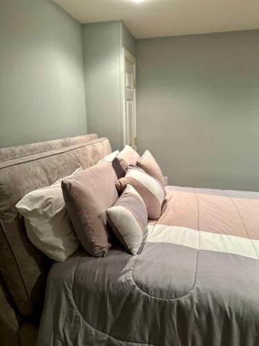 a pile of pillows sitting on top of a bed at The Oasis@Woodyard in Upper Marlboro