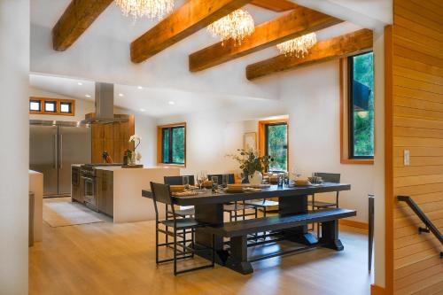 a dining room and kitchen with a table and chairs at Aspire in Glacier