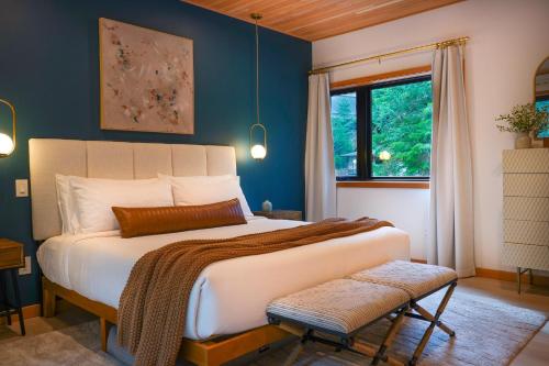 a bedroom with a large bed and a window at Aspire in Glacier