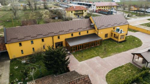 an overhead view of a yellow building with a roof at Pansion Mihića dvori in Babina Greda