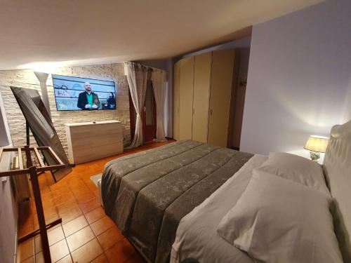 a bedroom with a bed and a flat screen tv at La Dolce Sosta - Tuscany in Chianciano Terme