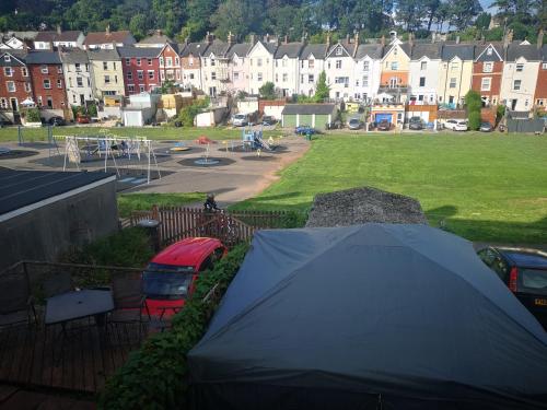 a tent in a parking lot with a park at Hideaway in Torquay