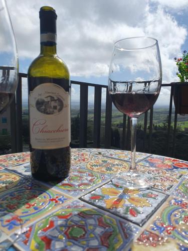 a bottle of wine sitting on a table with a glass at La Dolce Sosta - Tuscany in Chianciano Terme