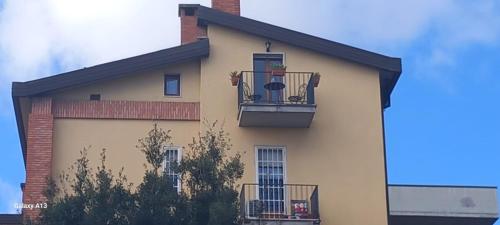 a building with a balcony with a chair on it at La Dolce Sosta - Tuscany in Chianciano Terme